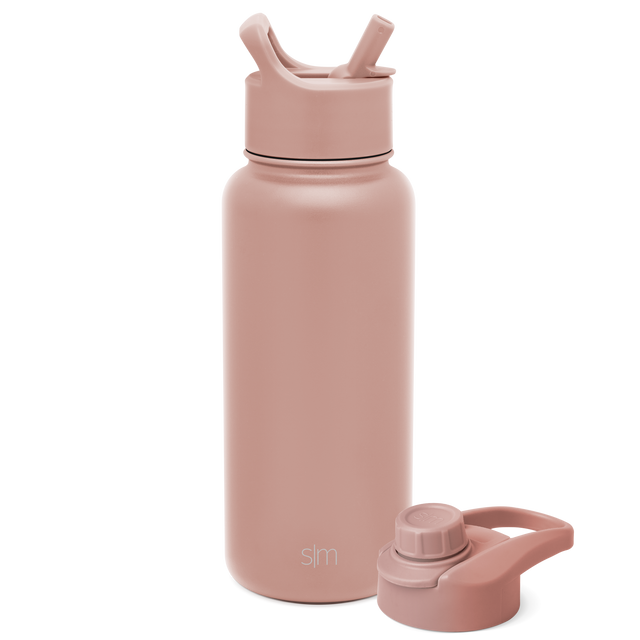 Dusty mauve water bottle with detachable lid on soft pink-beige background Dusty mauve water bottle with detachable lid on soft pink-beige background
