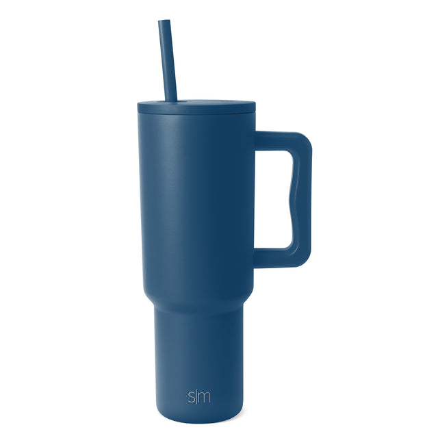 Teal blue Trek Tumbler with handle and matching straw on white background, featuring Simple Modern logo on lower front Teal blue Trek Tumbler with handle and matching straw on white background, featuring Simple Modern logo on lower front