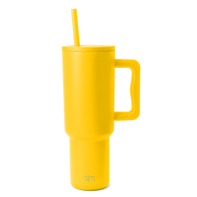 Yellow insulated tumbler with handle, lid, and matching straw on white background. Simple Modern brand. Yellow insulated tumbler with handle, lid, and matching straw on white background. Simple Modern brand.