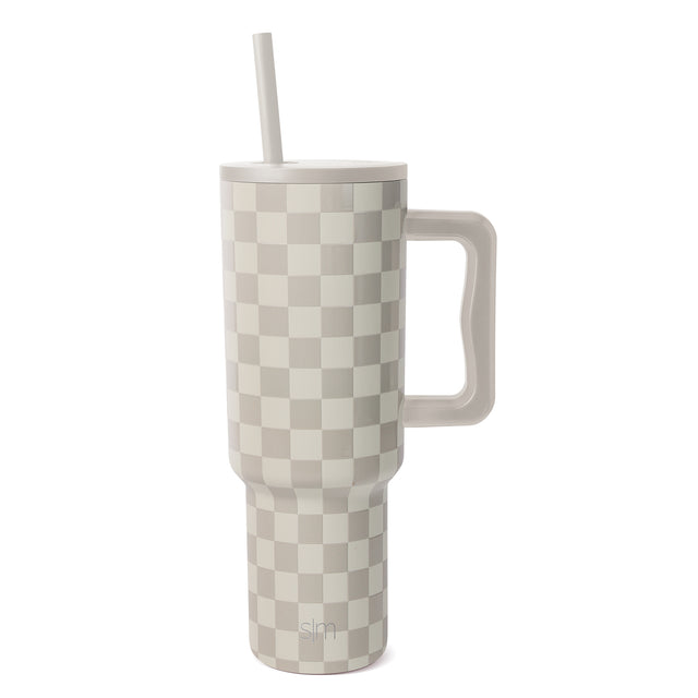 Tall insulated tumbler with handle and straw featuring a cream and taupe checkerboard pattern on white background Tall insulated tumbler with handle and straw featuring a cream and taupe checkerboard pattern on white background
