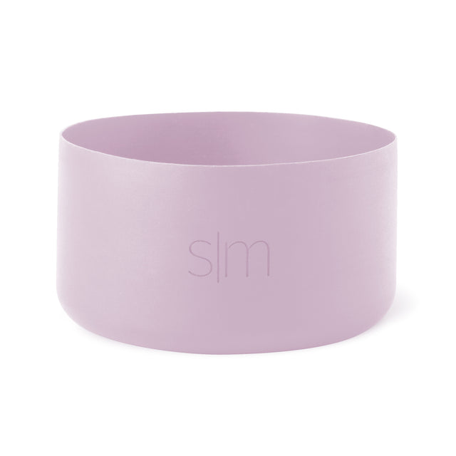 Soft lavender pink cylindrical drinking cup with curved sides and open top on white background Soft lavender pink cylindrical drinking cup with curved sides and open top on white background