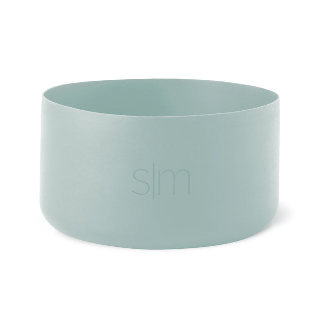 Soft sage green cylindrical boot vessel with muted celadon tone and subtle tonal variations throughout Soft sage green cylindrical boot vessel with muted celadon tone and subtle tonal variations throughout