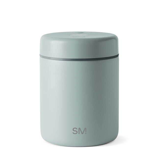 Sage green cylindrical canister with charcoal gray horizontal accent band, modern minimalist design Sage green cylindrical canister with charcoal gray horizontal accent band, modern minimalist design