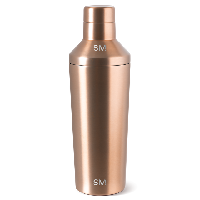 Cylindrical vessel with warm rose gold metallic finish and polished, reflective surface Cylindrical vessel with warm rose gold metallic finish and polished, reflective surface