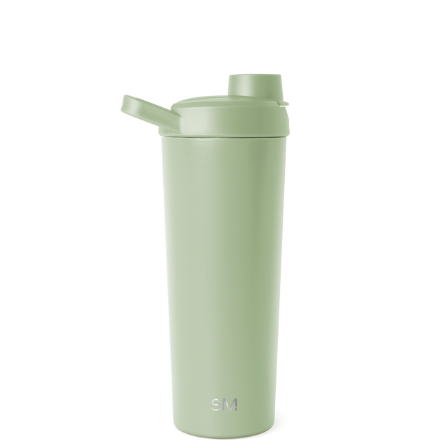 Soft sage green cylindrical tumbler with subtle tone variations on white background Soft sage green cylindrical tumbler with subtle tone variations on white background