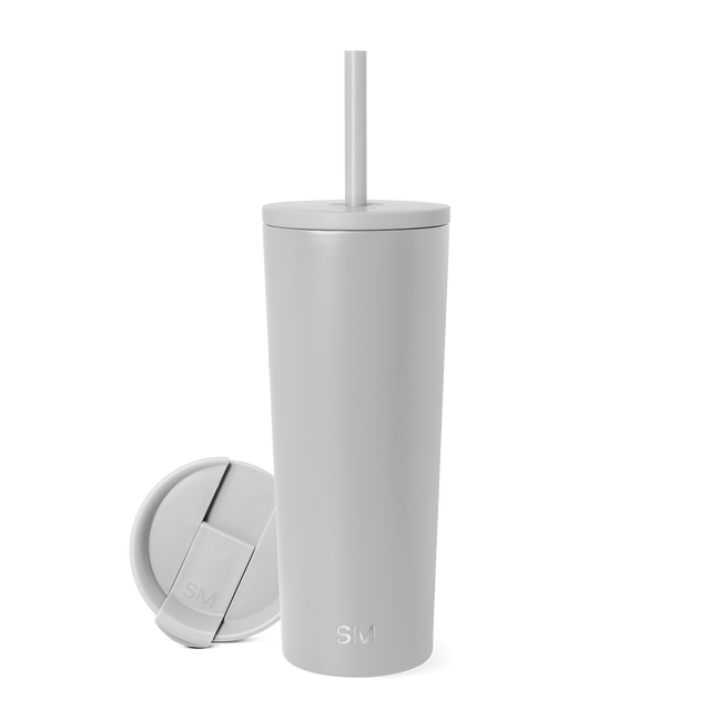 Pale gray-white tumbler with matching lid on bright white background Pale gray-white tumbler with matching lid on bright white background