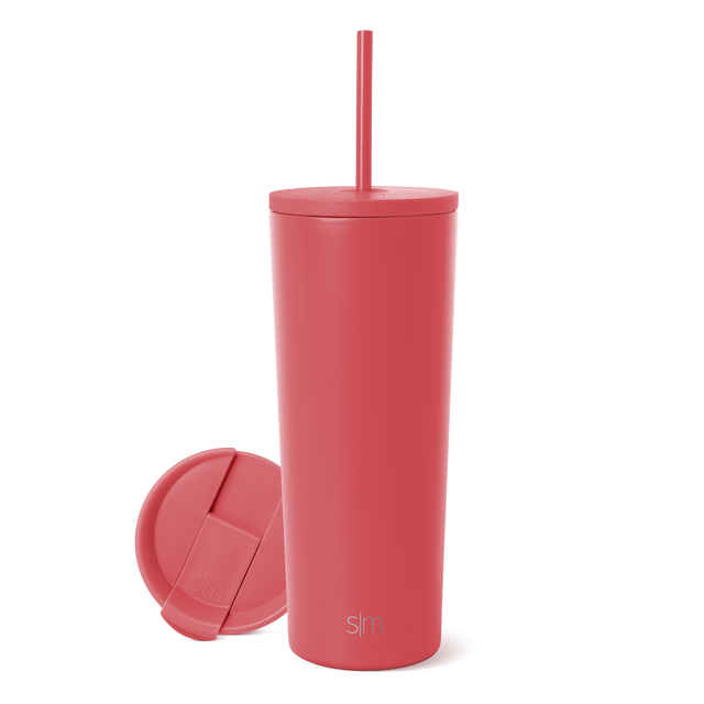 Coral-pink stainless steel tumbler with lid and straw on white background Coral-pink stainless steel tumbler with lid and straw on white background