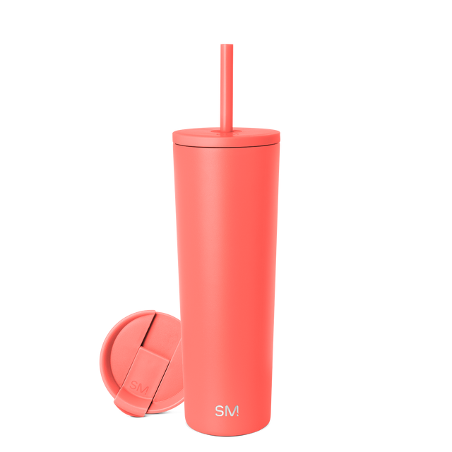 Coral-red tumbler with matching lid and straw on white background Coral-red tumbler with matching lid and straw on white background