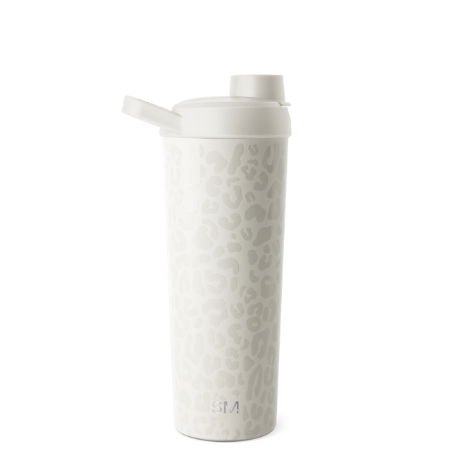 White insulated tumbler with lid displayed against a neutral background White insulated tumbler with lid displayed against a neutral background