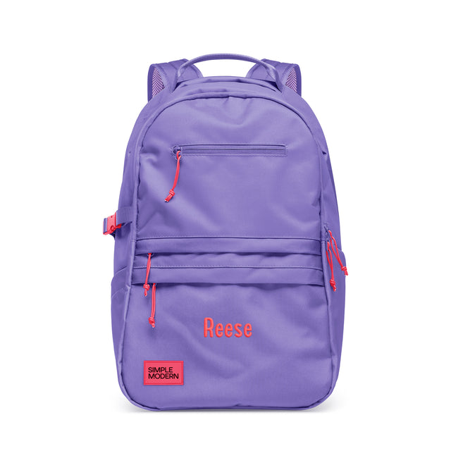 Periwinkle purple backpack with coral red accents, padded shoulder straps, multiple zippered pockets, and side compression straps. Features Periwinkle purple backpack with coral red accents, padded shoulder straps, multiple zippered pockets, and side compression straps. Features