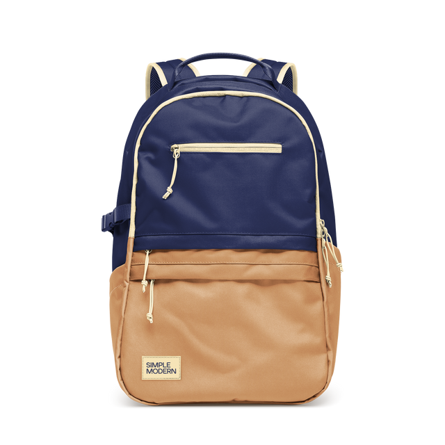 Two-tone backpack with deep navy blue upper portion, warm tan brown lower half, and cream trim accents. Two-tone backpack with deep navy blue upper portion, warm tan brown lower half, and cream trim accents.