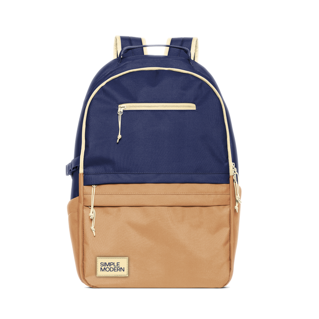 Two-tone navy blue and tan backpack with cream trim and hardware Two-tone navy blue and tan backpack with cream trim and hardware