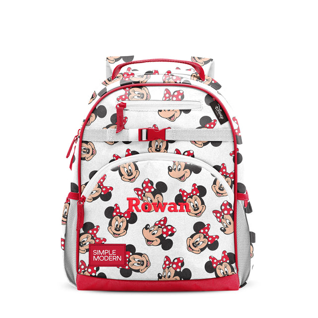 Red and cream children's backpack with Minnie Mouse character pattern, multiple zippered pockets, padded shoulder straps, top handle, side mesh pockets, and red chest strap buckle. Simple Modern brand label visible. Red and cream children's backpack with Minnie Mouse character pattern, multiple zippered pockets, padded shoulder straps, top handle, side mesh pockets, and red chest strap buckle. Simple Modern brand label visible.