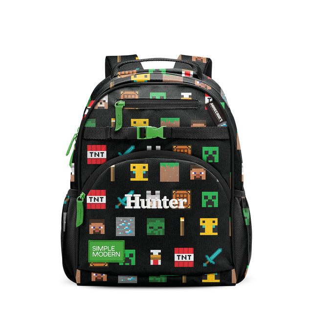 Black school backpack with pixelated yellow, red, white, and blue blocks, green straps and handles, front pockets labeled Black school backpack with pixelated yellow, red, white, and blue blocks, green straps and handles, front pockets labeled
