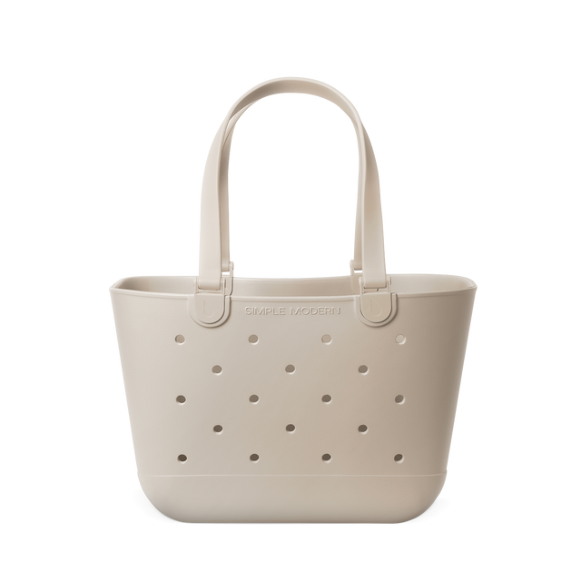 Beige cream colored tote bag with handles displayed against a bright white background Beige cream colored tote bag with handles displayed against a bright white background