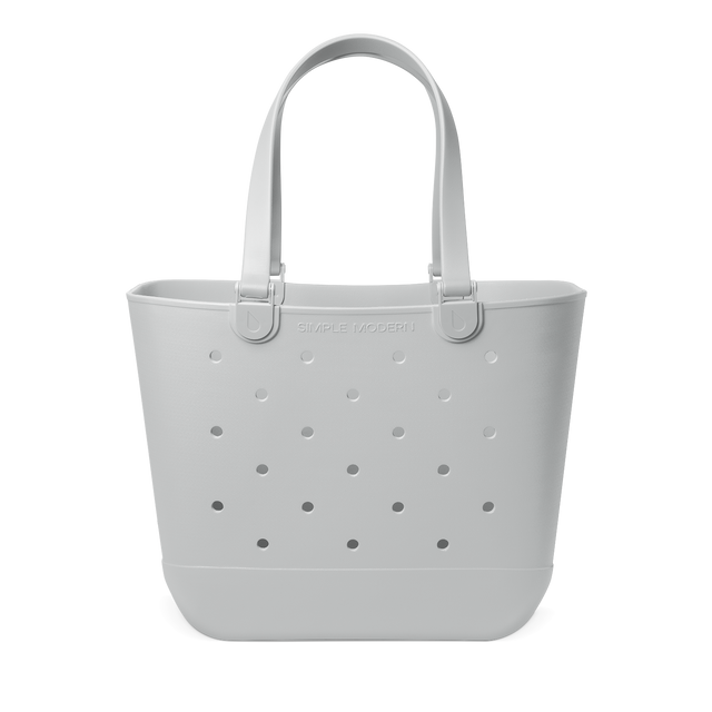 Pale gray soft tote bag with handles displayed against white background Pale gray soft tote bag with handles displayed against white background