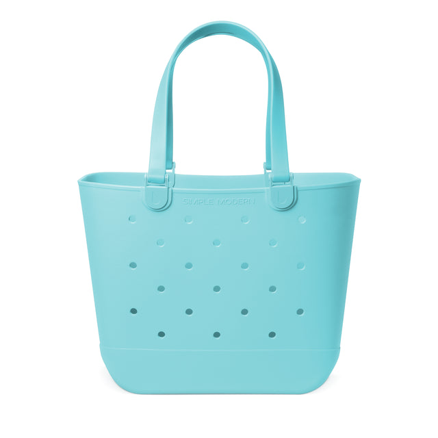 Soft turquoise perforated tote bag with padded handles and flat bottom against white background. Features Soft turquoise perforated tote bag with padded handles and flat bottom against white background. Features