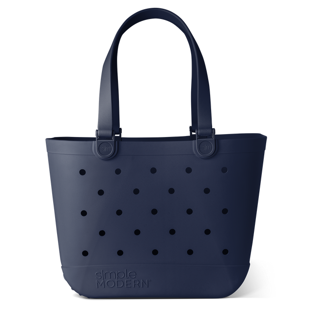 Navy blue tote bag with black circular perforations and accent details Navy blue tote bag with black circular perforations and accent details