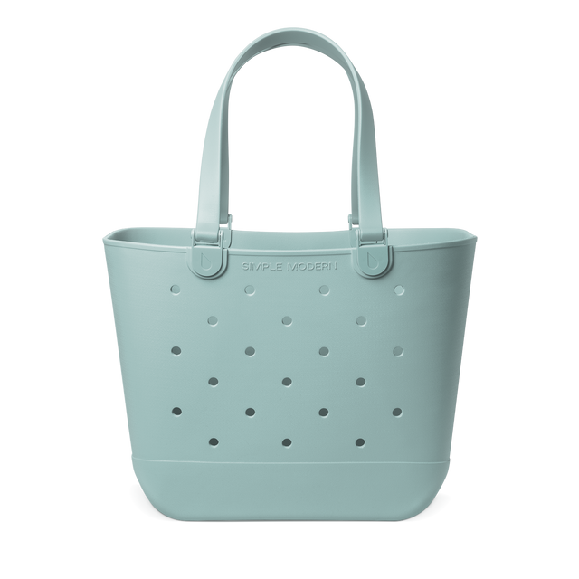 Sage green canvas tote bag with handles, shown against a white background. Sage green canvas tote bag with handles, shown against a white background.