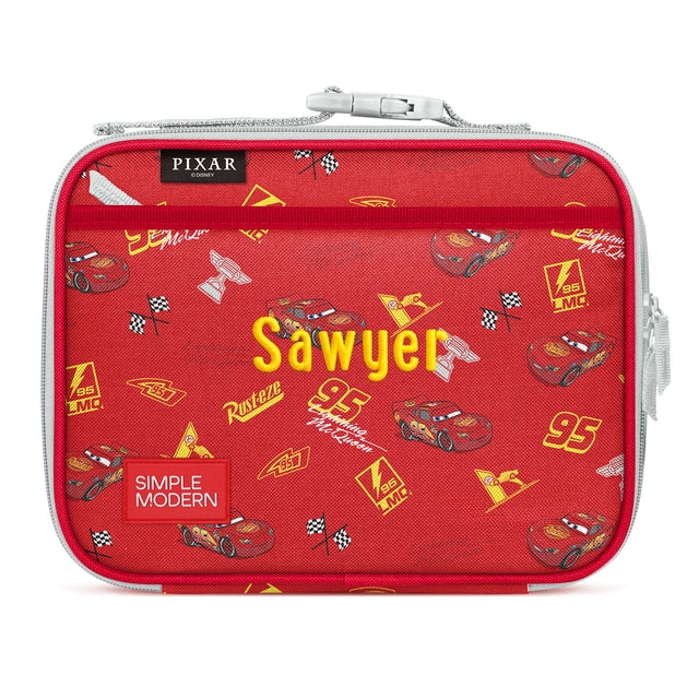 Red insulated lunchbox with Cars movie design featuring character Sawyer, checkered flags, race cars with number 95, mesh pockets, gray zipper, and yellow text on white background. Red insulated lunchbox with Cars movie design featuring character Sawyer, checkered flags, race cars with number 95, mesh pockets, gray zipper, and yellow text on white background.