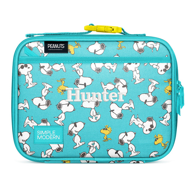 Turquoise Simple Modern lunch box with Snoopy and Woodstock characters from Peanuts printed throughout, featuring a yellow zipper, carrying handle, and side pockets on white background. Turquoise Simple Modern lunch box with Snoopy and Woodstock characters from Peanuts printed throughout, featuring a yellow zipper, carrying handle, and side pockets on white background.