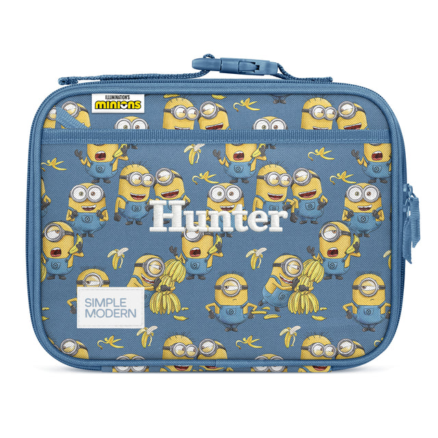 Slate blue Simple Modern insulated lunch box with repeating Minions characters in yellow and blue, featuring a blue zippered closure, shoulder strap, and personalized Slate blue Simple Modern insulated lunch box with repeating Minions characters in yellow and blue, featuring a blue zippered closure, shoulder strap, and personalized