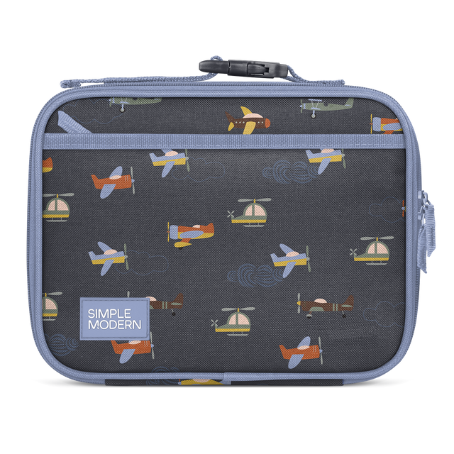 Charcoal gray lunch box with periwinkle blue trim and handles, featuring interior pattern of colorful aircraft in orange, yellow, blue, and cream. Charcoal gray lunch box with periwinkle blue trim and handles, featuring interior pattern of colorful aircraft in orange, yellow, blue, and cream.