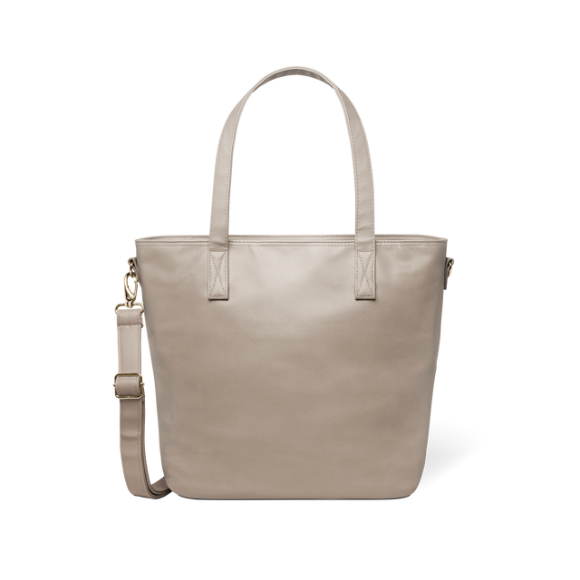 Beige tote bag with metal hardware accents displayed against a white background Beige tote bag with metal hardware accents displayed against a white background
