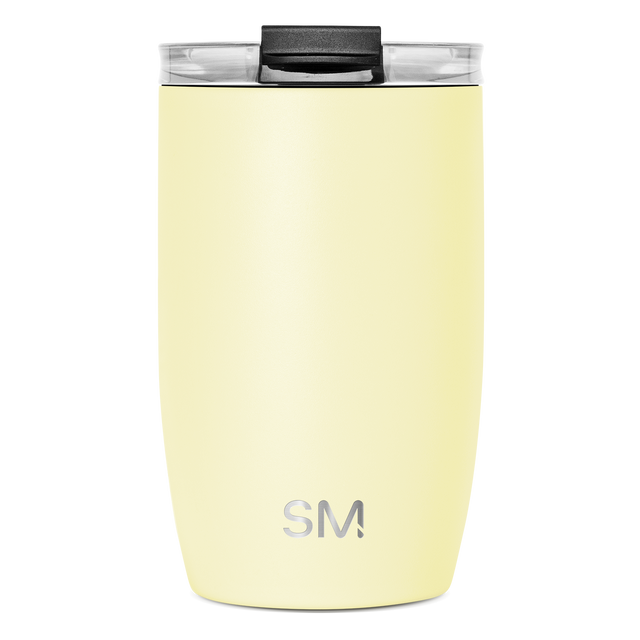 Pale yellow tumbler with clear lid and black handle grip Pale yellow tumbler with clear lid and black handle grip