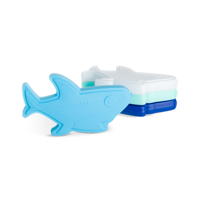 Four stackable shark-shaped ice cube trays in sky blue, mint green, white, and navy blue arranged against a white background. Four stackable shark-shaped ice cube trays in sky blue, mint green, white, and navy blue arranged against a white background.