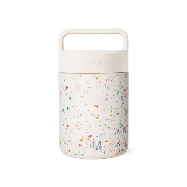 Cream-colored cylindrical container with terrazzo-patterned lower section featuring multicolored speckles on neutral background Cream-colored cylindrical container with terrazzo-patterned lower section featuring multicolored speckles on neutral background