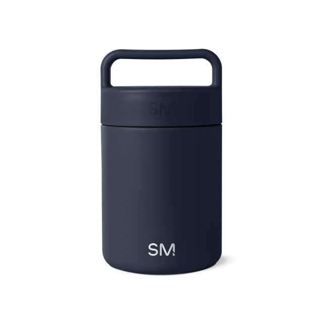 Navy blue glass jar with dark cap and handle on white background Navy blue glass jar with dark cap and handle on white background