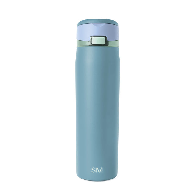 Soft teal glass bottle with dark teal rim and pale blue lid cap Soft teal glass bottle with dark teal rim and pale blue lid cap