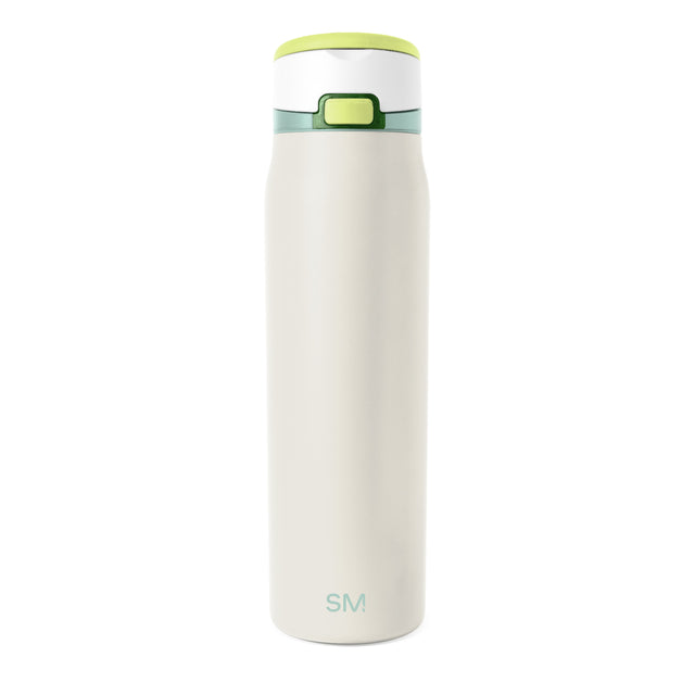 Cream-colored insulated tumbler with lime green rim and base against white background Cream-colored insulated tumbler with lime green rim and base against white background