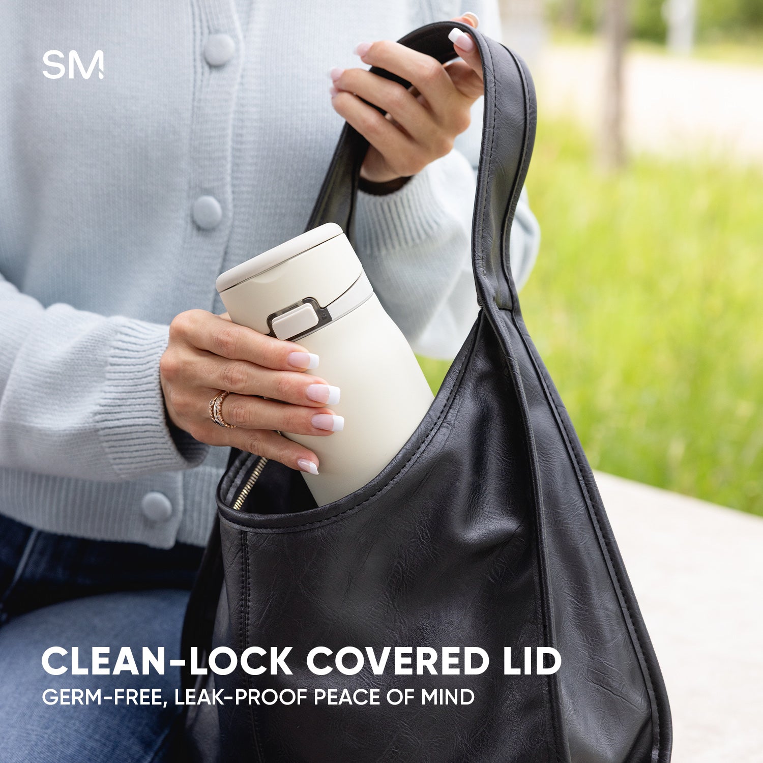 Woman putting Mesa Loop into a purse with text that calls out the clean-lock covered lid