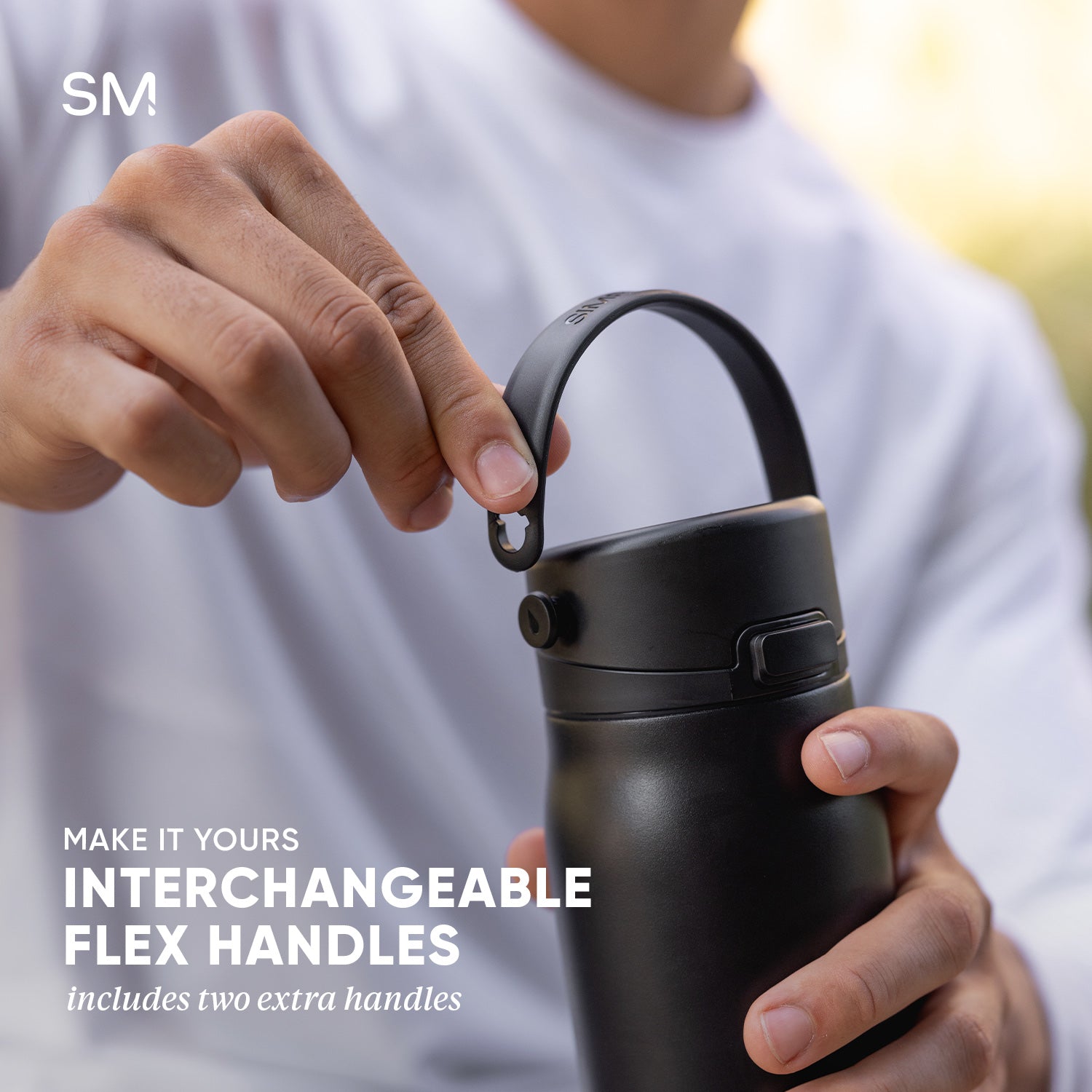 Man holding Mesa Sport water bottle showing the interchangeable flex handles and text that says two extra handles are included
