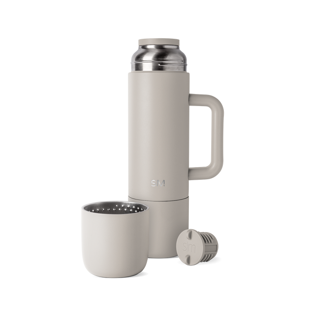 Greige-toned coffee maker with neutral beige-gray exterior walls and soft interior components visible on the lid and brewing chamber Greige-toned coffee maker with neutral beige-gray exterior walls and soft interior components visible on the lid and brewing chamber