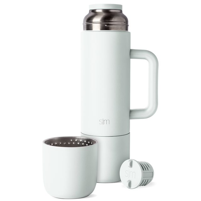 Soft mint-green ceramic vessel with brushed metal accents and neutral minimalist design Soft mint-green ceramic vessel with brushed metal accents and neutral minimalist design
