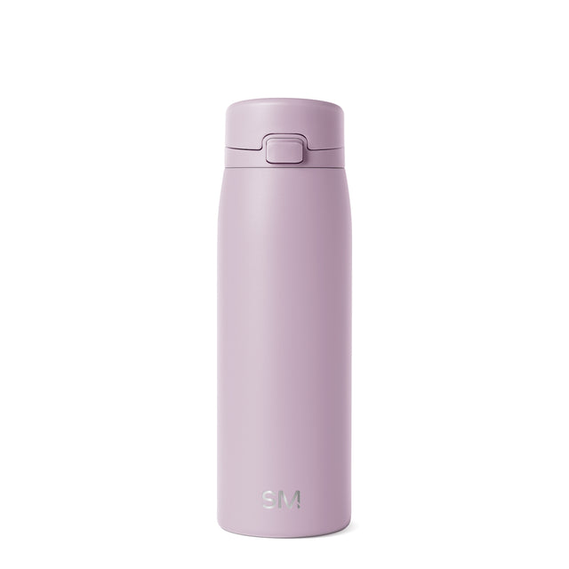 Soft mauve glass bottle with dusty lilac coloring displayed against a neutral off-white background Soft mauve glass bottle with dusty lilac coloring displayed against a neutral off-white background