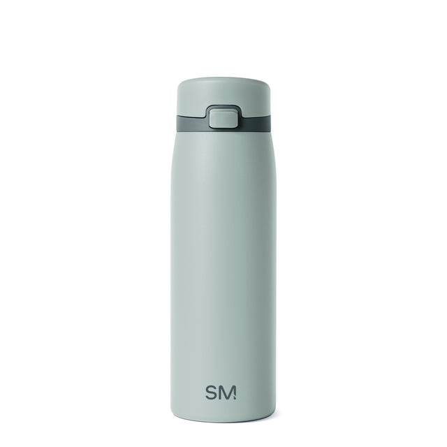 Soft sage green glass bottle with darker charcoal accents, featuring a minimalist design against a neutral background. Soft sage green glass bottle with darker charcoal accents, featuring a minimalist design against a neutral background.