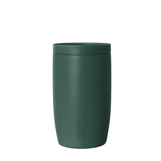 Muted sage green insulated tumbler with lid against neutral off-white background Muted sage green insulated tumbler with lid against neutral off-white background