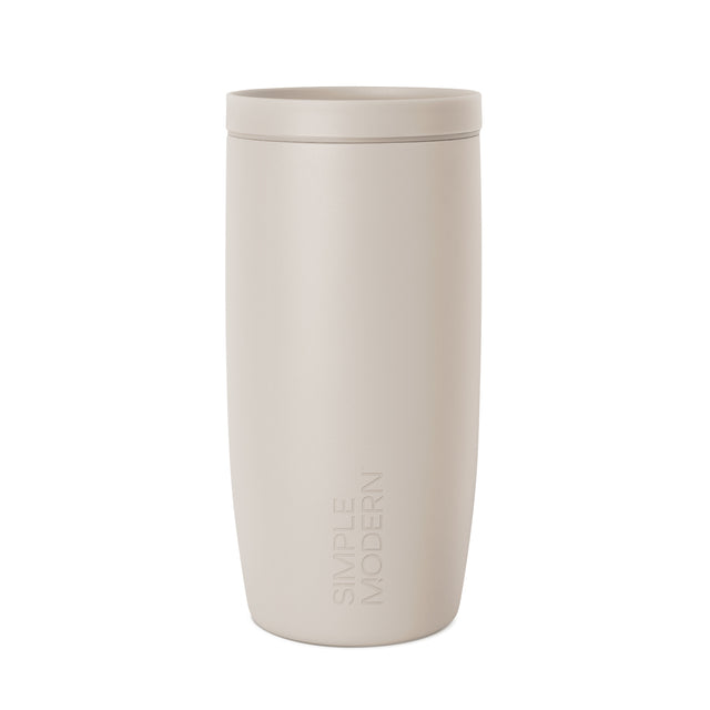Cream-colored cylindrical vessel with warm beige tone, displayed against neutral background for minimalist aesthetic appearance. Cream-colored cylindrical vessel with warm beige tone, displayed against neutral background for minimalist aesthetic appearance.