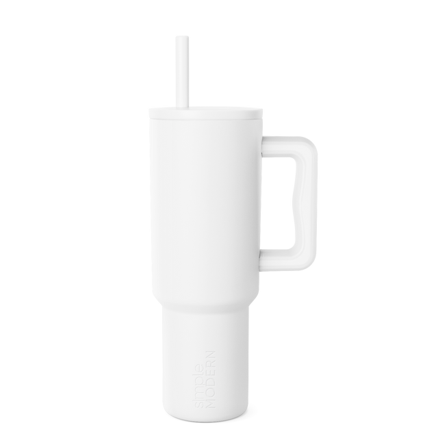 White insulated tumbler with matching white straw on light gray background White insulated tumbler with matching white straw on light gray background