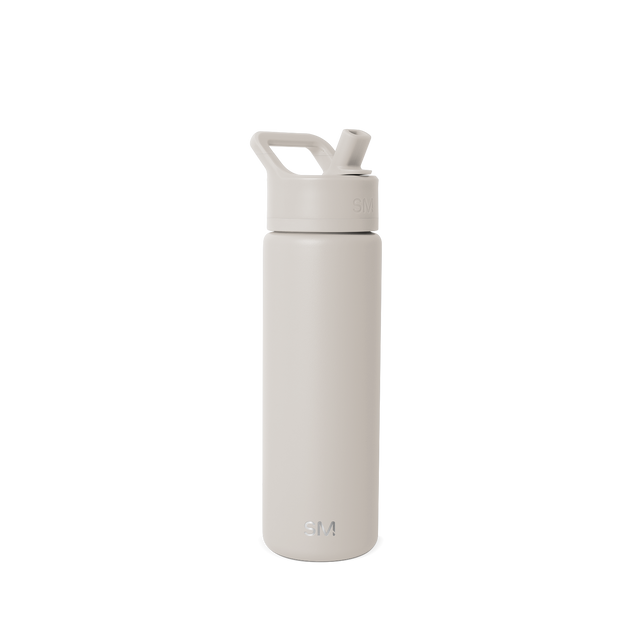 Beige and cream colored water bottle against light off-white background Beige and cream colored water bottle against light off-white background