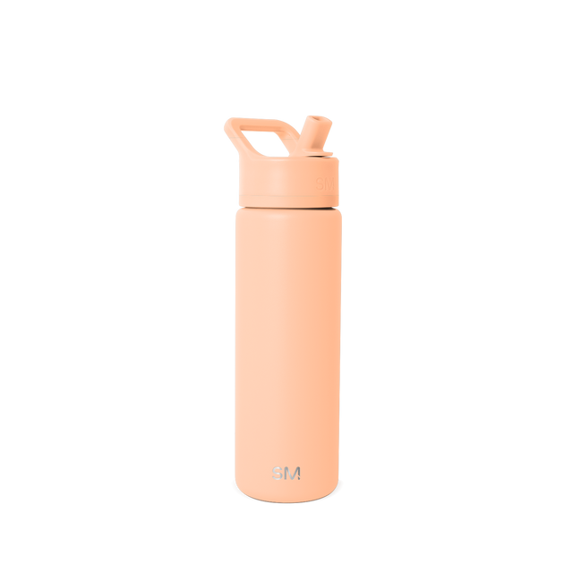 Tall cylindrical water bottle in soft peachy-beige with flip-top cap, angled straw opening, and curved carry handle Tall cylindrical water bottle in soft peachy-beige with flip-top cap, angled straw opening, and curved carry handle