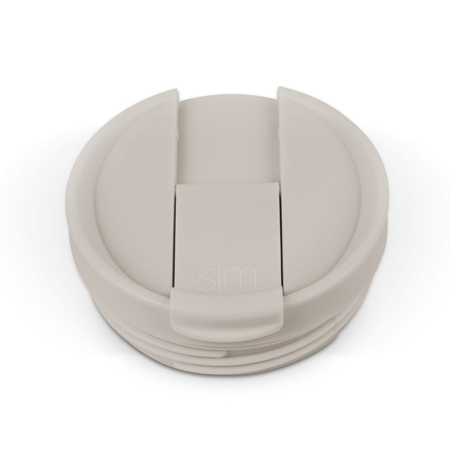 Beige and cream colored flip-top lid with matching components in light taupe, shown in monochromatic neutral tones Beige and cream colored flip-top lid with matching components in light taupe, shown in monochromatic neutral tones