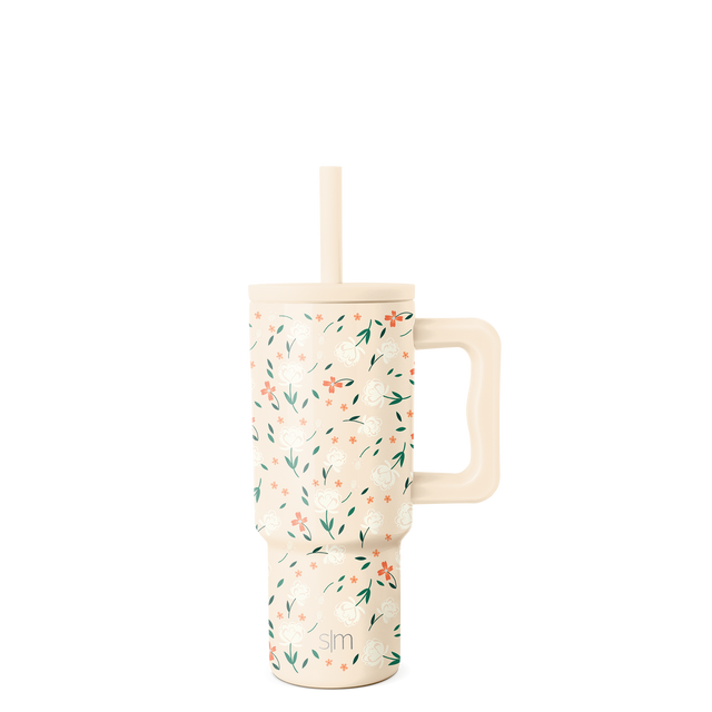 Cream mug with scattered coral-pink flowers, sage green leaves, and pale botanical elements in a delicate floral pattern Cream mug with scattered coral-pink flowers, sage green leaves, and pale botanical elements in a delicate floral pattern