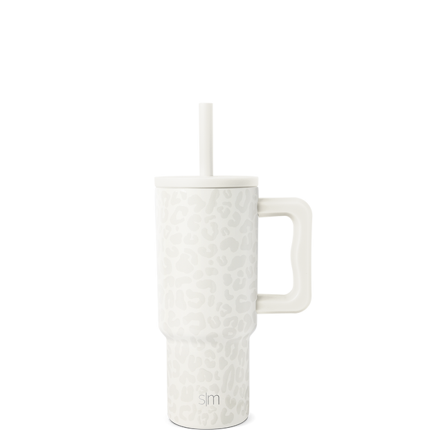 White tumbler with white straw on light gray background White tumbler with white straw on light gray background