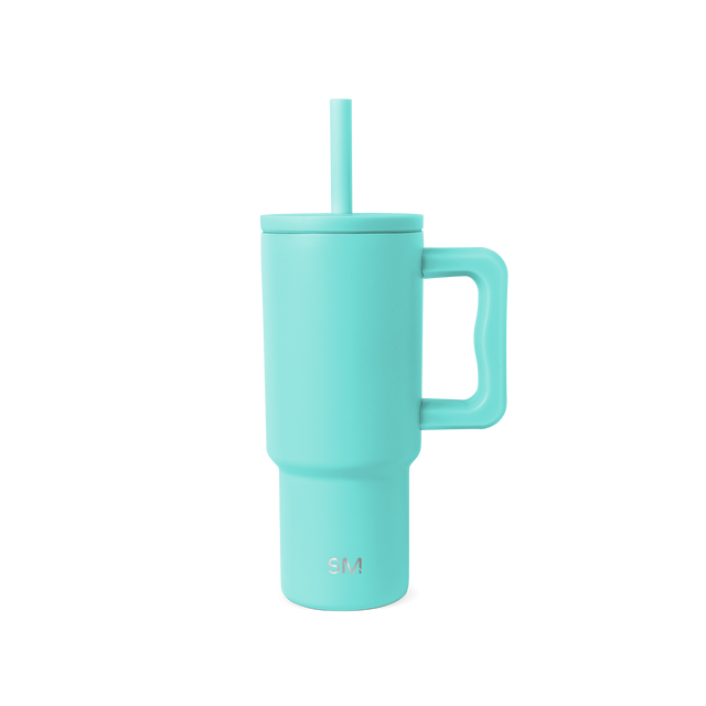 Soft turquoise blue-green cylindrical vessel with matching handle and lid, shown against neutral background. Soft turquoise blue-green cylindrical vessel with matching handle and lid, shown against neutral background.