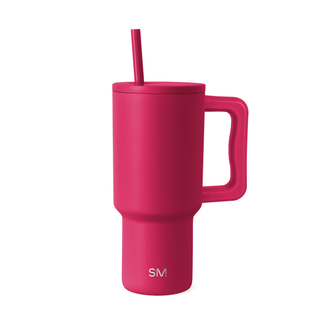 Hot pink tumbler with lid and straw against white background Hot pink tumbler with lid and straw against white background